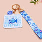 Acrylic epoxy underwater fish keychain with a large acrylic charm of a blue fish with the quote buy a man eat fish he day teach fish man to a lifetime, a smaller charm of a cute fish and a matching underwater lanyard.
