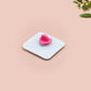A clear acrylic pin badge with a pink heart-shaped pin back clasp. The design of the pin badge is of a cute chibi blue fish with the quote buy a man eat fish he day teach fish man to a lifetime.