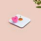 A clear acrylic pin badge with a pink heart-shaped pin back clasp. The design of the pin badge is of a cute chibi blue fish with the quote buy a man eat fish he day teach fish man to a lifetime.