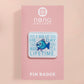 A clear acrylic pin badge with a pink heart-shaped pin back clasp. The design of the pin badge is of a cute chibi blue fish with the quote buy a man eat fish he day teach fish man to a lifetime.