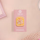 A yellow acrylic pin badge with a pink heart-shaped pin back clasp. The design of the pin badge is of a cute mouse napping in bed with a patchwork quilt with the quote can't mistakey if not awakey.