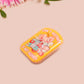 A yellow acrylic pin badge with a pink heart-shaped pin back clasp. The design of the pin badge is of a cute mouse napping in bed with a patchwork quilt with the quote can't mistakey if not awakey.