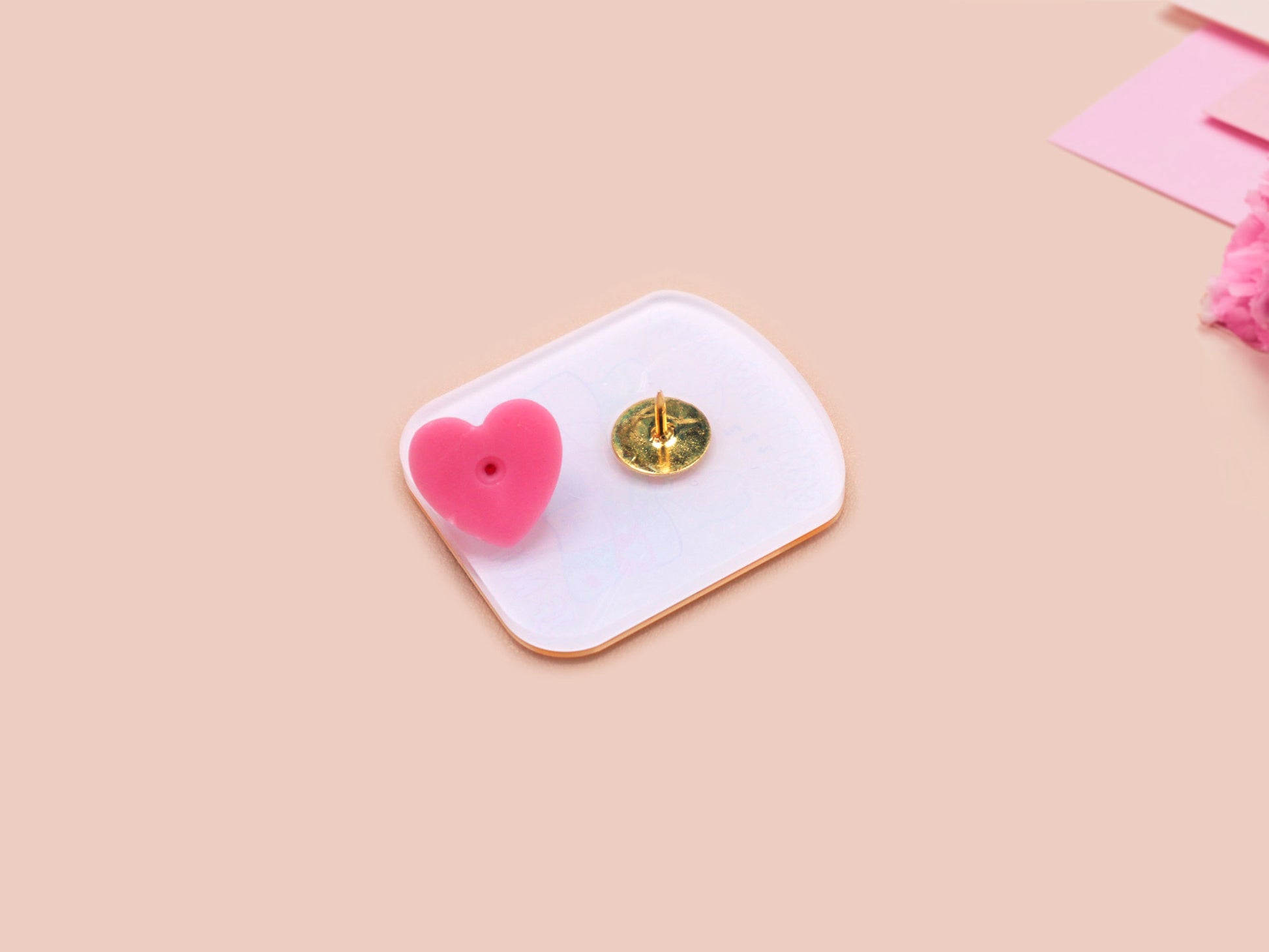 A yellow acrylic pin badge with a pink heart-shaped pin back clasp. The design of the pin badge is of a cute mouse napping in bed with a patchwork quilt with the quote can't mistakey if not awakey.