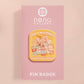 A yellow acrylic pin badge with a pink heart-shaped pin back clasp. The design of the pin badge is of a cute mouse napping in bed with a patchwork quilt with the quote can't mistakey if not awakey.