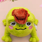 An adorable green frog plushie toy with cute embroidered eyes and facial expression, wearing a cowboy hat with a brown ribbon, and a hang tag describing the frog as Carl.