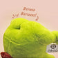 An adorable green frog plushie toy with cute embroidered eyes and facial expression, wearing a cowboy hat with a brown ribbon, and a hang tag describing the frog as Carl.