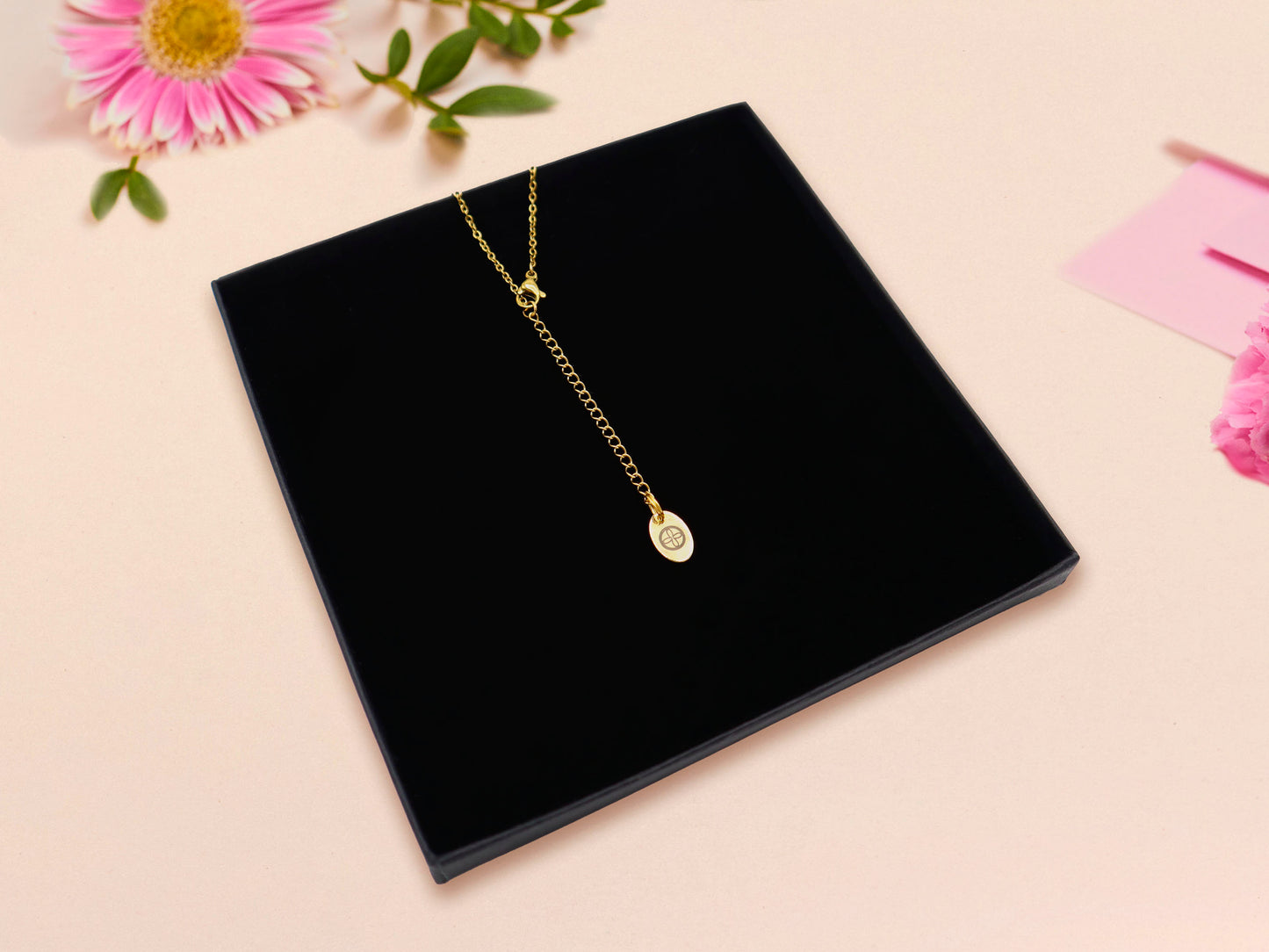Gold chain with gold extender and Nona Gallery tag charm in black gift box.