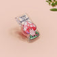 This cute transparent acrylic pin badge has a pink rubber heart shrimp pin-back clasp. The design is of a chibi cartoon mushroom with the text "Come back with a warrant."