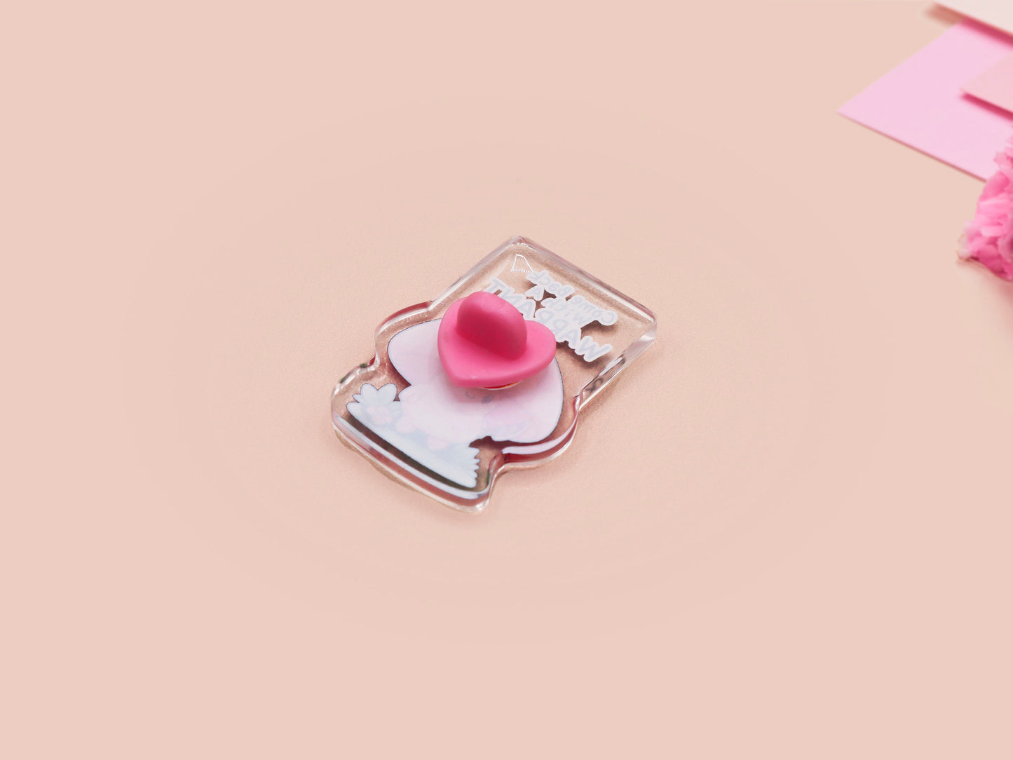 This cute transparent acrylic pin badge has a pink rubber heart shrimp pin-back clasp. The design is of a chibi cartoon mushroom with the text "Come back with a warrant."