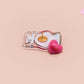 This cute transparent acrylic pin badge has a pink rubber heart shrimp pin-back clasp. The design is of a chibi cartoon mushroom with the text "Come back with a warrant."