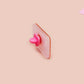 A clear acrylic pin badge with a pink heart-shaped pin back clasp. The design of the pin badge is of a cute singing cowboy cat from the viral internet meme with the song quote Country roads take me home to the place I belong