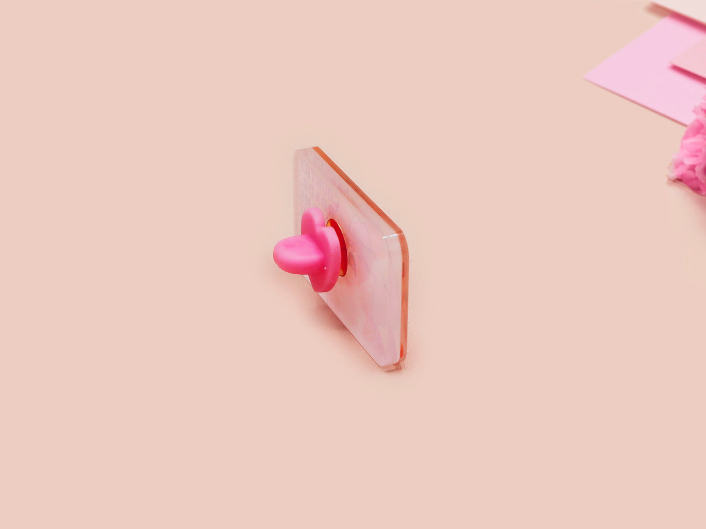 A clear acrylic pin badge with a pink heart-shaped pin back clasp. The design of the pin badge is of a cute singing cowboy cat from the viral internet meme with the song quote Country roads take me home to the place I belong