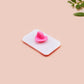 A clear acrylic pin badge with a pink heart-shaped pin back clasp. The design of the pin badge is of a cute singing cowboy cat from the viral internet meme with the song quote Country roads take me home to the place I belong