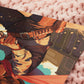 A square art print depicting a cowgirl gunslinger in a dramatic pose in the wild west outside a saloon.