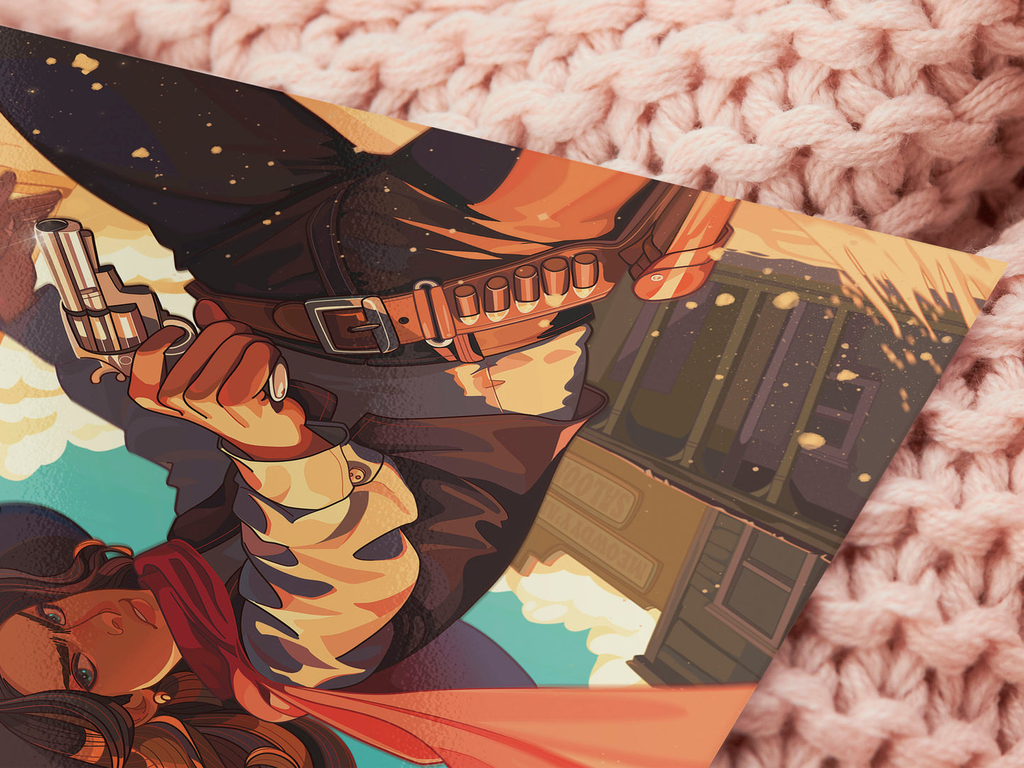 A square art print depicting a cowgirl gunslinger in a dramatic pose in the wild west outside a saloon.