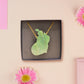 Adorable cute capybara with an orange on its head necklace made of wood and glitter pearlescent acrylic with a gold chain, displayed in a velvet gift box with a unique cute capybara sleeve design.