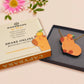 Adorable cute capybara with an orange on its head necklace made of wood and glitter pearlescent acrylic with a gold chain, displayed in a velvet gift box with a unique cute capybara sleeve design.