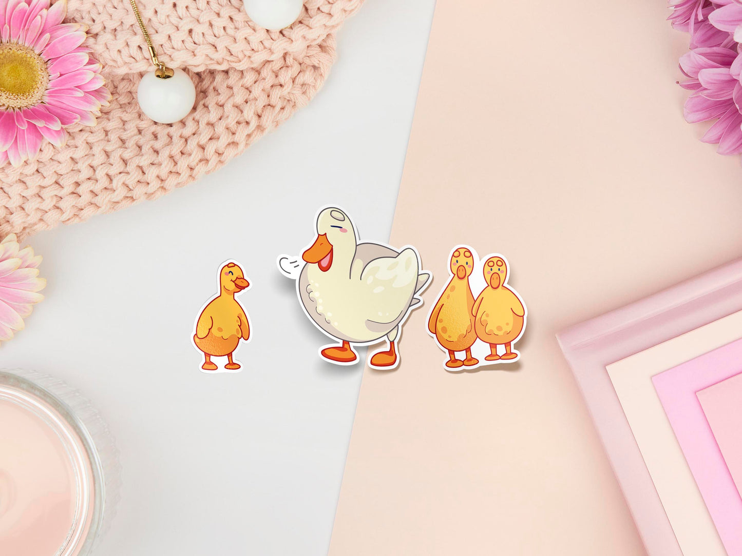 Three stickers of digitally illustrated cartoon ducks, one is a white adult duck the other are three small yellow ducklings