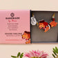 An adorable cute dachshund sausage dog necklace in a french outfit, a beret and striped top, connected to a speech bubble that is engraved with the words oui oui! displayed in a velvet gift box with a unique cute dachshund sleeve design.