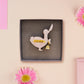 An adorable cute goose with a bell and pink bow brooch pin badge made of wood and glitter pearlescent acrylic with a gold chain is displayed in a velvet gift box with a unique cute goose sleeve design.