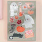 Large sticker sheet of digital illustration cartoon of ghosts, mushrooms, leaves, pumpkins, tea, wellington boots, black cats and other assorted autumn items 