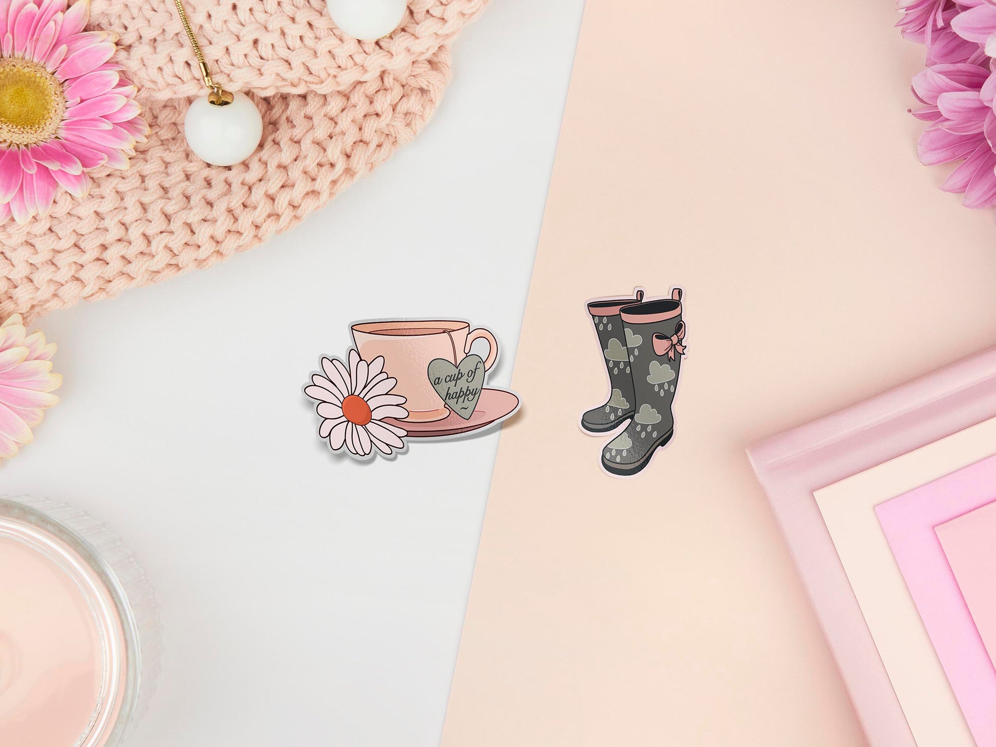 Two stickers of digital illustration cartoons of a cup of tea with glowers and the words a cup of happy and wellington boots with a rain cloud pattern and bow