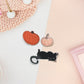 Three stickers of digital illustration cartoons of pumpkins and a playful black cat