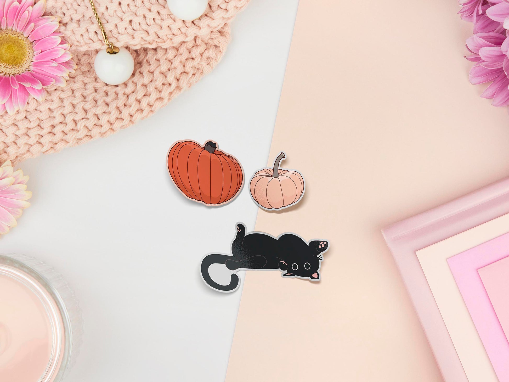 Three stickers of digital illustration cartoons of pumpkins and a playful black cat