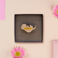 An adorable cute otter holding a clam seashell with a pearl inside brooch pin badge made of wood and glitter pearlescent acrylic with a gold chain is displayed in a velvet gift box with a unique cute otter sleeve design.