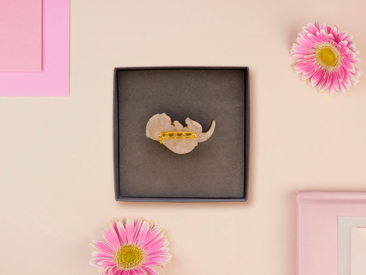 An adorable cute otter holding a clam seashell with a pearl inside brooch pin badge made of wood and glitter pearlescent acrylic with a gold chain is displayed in a velvet gift box with a unique cute otter sleeve design.