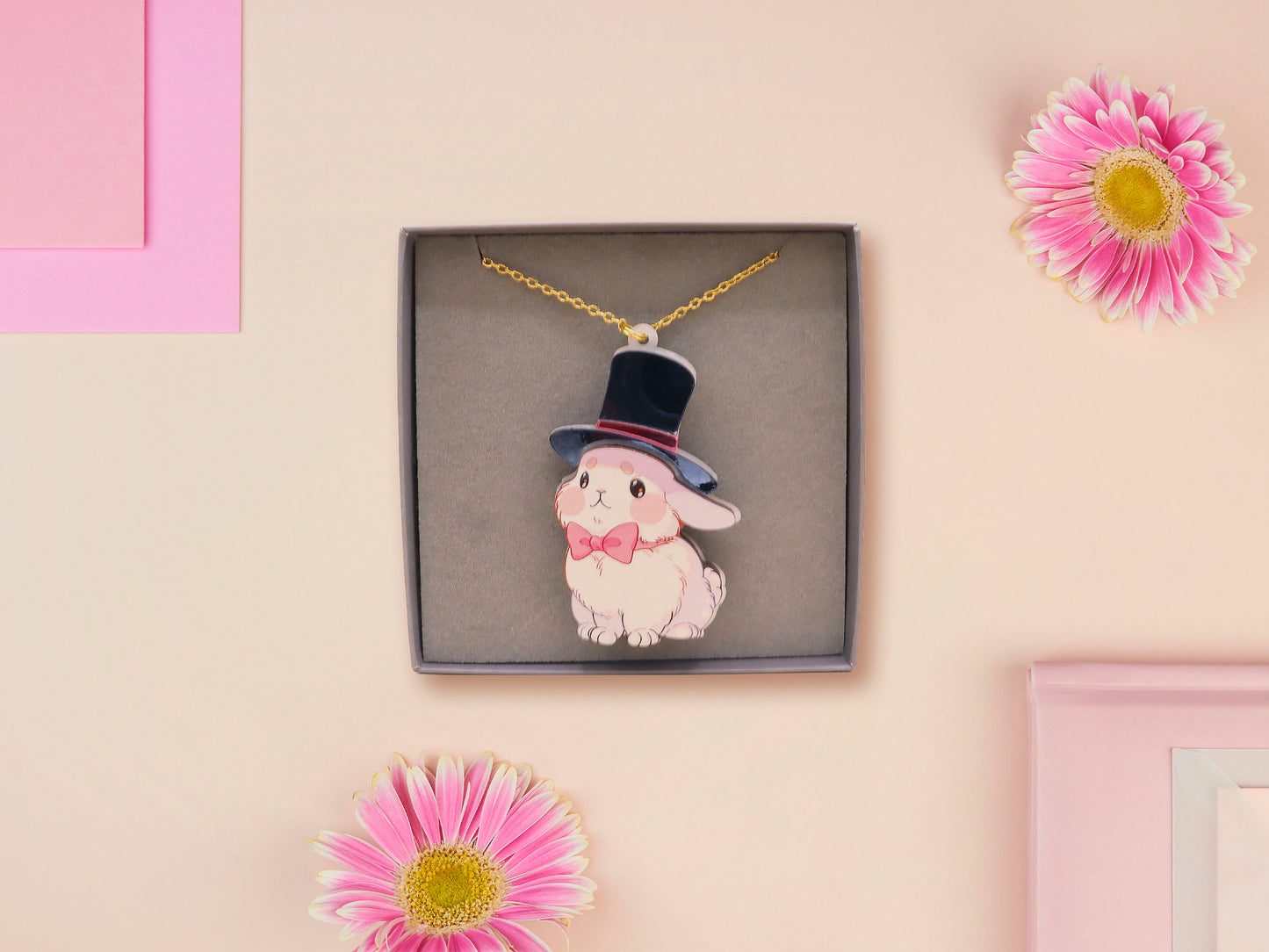 Adorable cute white bunny rabbit wearing a top hat and now tie necklace made of wood and mirror acrylic with a gold chain, displayed in a velvet gift box with a unique cute rabbit sleeve design.