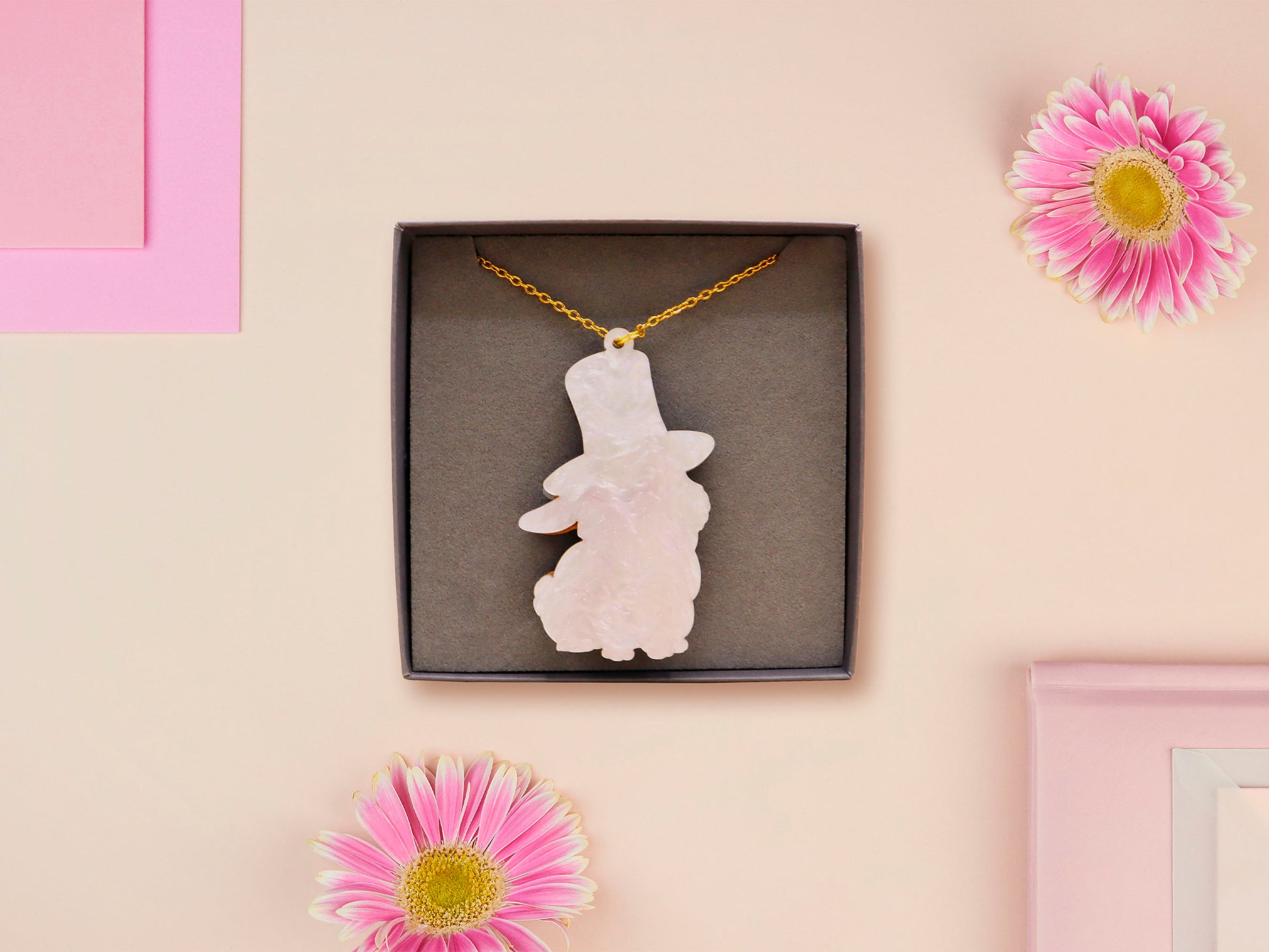 Adorable cute white bunny rabbit wearing a top hat and now tie necklace made of wood and mirror acrylic with a gold chain, displayed in a velvet gift box with a unique cute rabbit sleeve design.