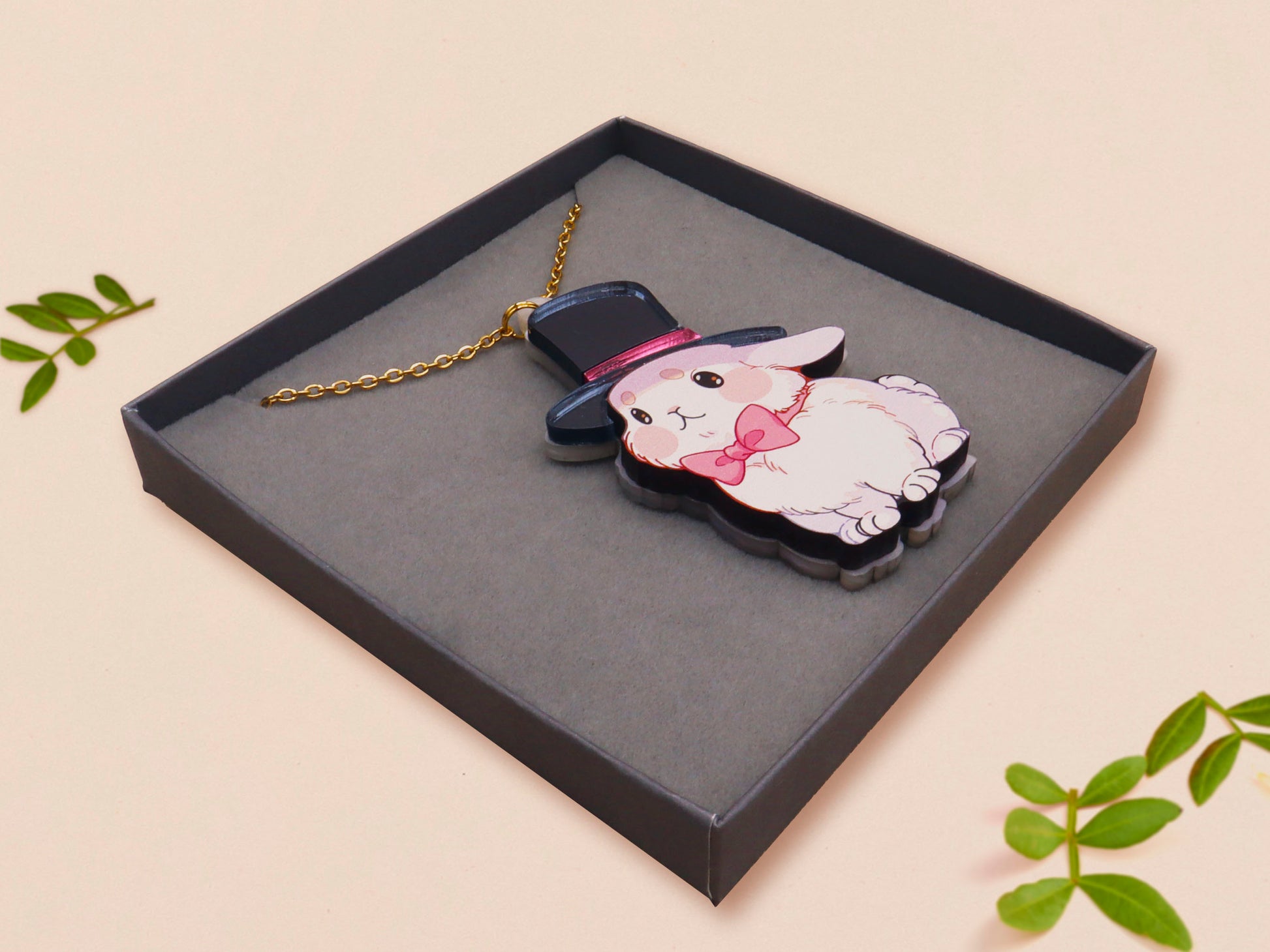 Adorable cute white bunny rabbit wearing a top hat and now tie necklace made of wood and mirror acrylic with a gold chain, displayed in a velvet gift box with a unique cute rabbit sleeve design.