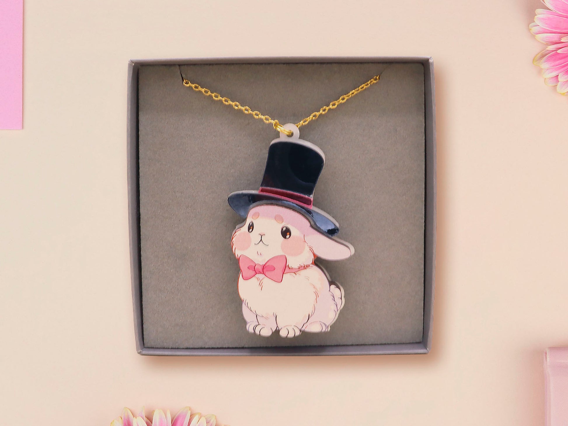 Adorable cute white bunny rabbit wearing a top hat and now tie necklace made of wood and mirror acrylic with a gold chain, displayed in a velvet gift box with a unique cute rabbit sleeve design.