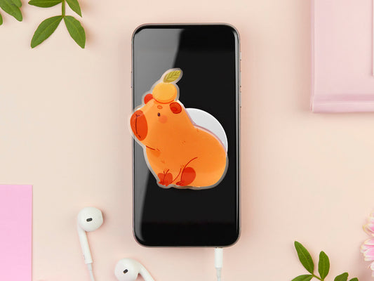 Cute acrylic popsocket phone grip of a capybara with an orange on it's head