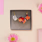An adorable cute dachshund sausage dog necklace in a french outfit, a beret and striped top, connected to a speech bubble that is engraved with the words oui oui! displayed in a velvet gift box with a unique cute dachshund sleeve design.