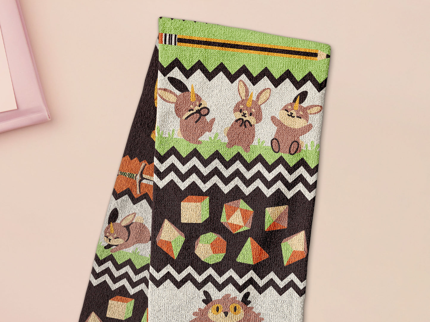 Cute knitted scarf with cute chibi Tabletop RPG Cryptid Monsters from DND such as Owlbears, Almiraj Rabbits, a Displacer Beast Kitten, Beholder, sleeping baby dragon and Mimic chests