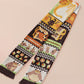 Cute knitted scarf with cute chibi Tabletop RPG Cryptid Monsters from DND such as Owlbears, Almiraj Rabbits, a Displacer Beast Kitten, Beholder, sleeping baby dragon and Mimic chests