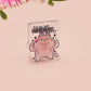 Cute transparent acrylic pin badge with a pink heart-shaped pin back clasp. The design of the badge is a chibi hench and buff cat with the quote Did you justPSPSPSPSPST my gurl?!