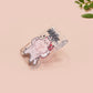 Cute transparent acrylic pin badge with a pink heart-shaped pin back clasp. The design of the badge is a chibi hench and buff cat with the quote Did you justPSPSPSPSPST my gurl?!