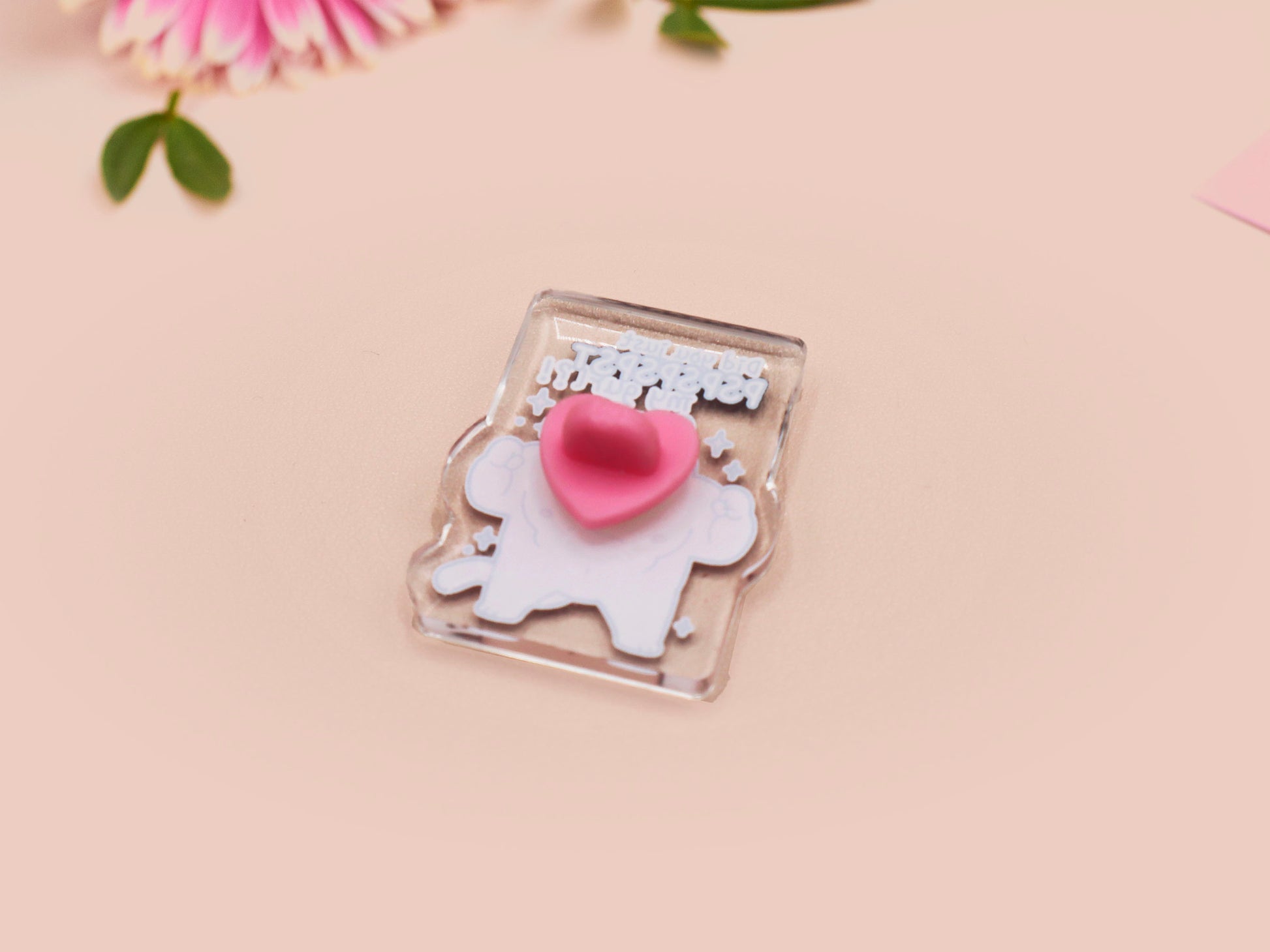 Cute transparent acrylic pin badge with a pink heart-shaped pin back clasp. The design of the badge is a chibi hench and buff cat with the quote Did you justPSPSPSPSPST my gurl?!