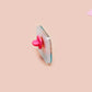 A clear acrylic pin badge with a pink heart-shaped pin back clasp. The design of the pin badge is of a cute relaxing capybara in water with a face mask with the quote don't worry be cappy.