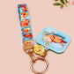 Acrylic epoxy blue capybara spa keychain with a large acrylic charm of a capybara floating in water relaxing with a face mask with the quote don't worry be cappy, a smaller charm of a cute rubber duck and a matching capybara spa day lanyard.