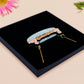 A wooden and glitter acrylic necklace with gold chain in a black box of a cute family of ducks two adult white ducks and four yellow ducklings playing and splashing in the water