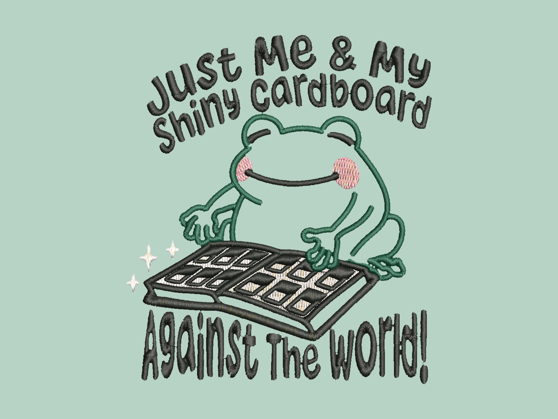 An embroidered green t-shirt design of a cute frog happily looking at his binder of tcg trading cards surrounded by the quote Just Me And My Shiny Cardboard Against The World