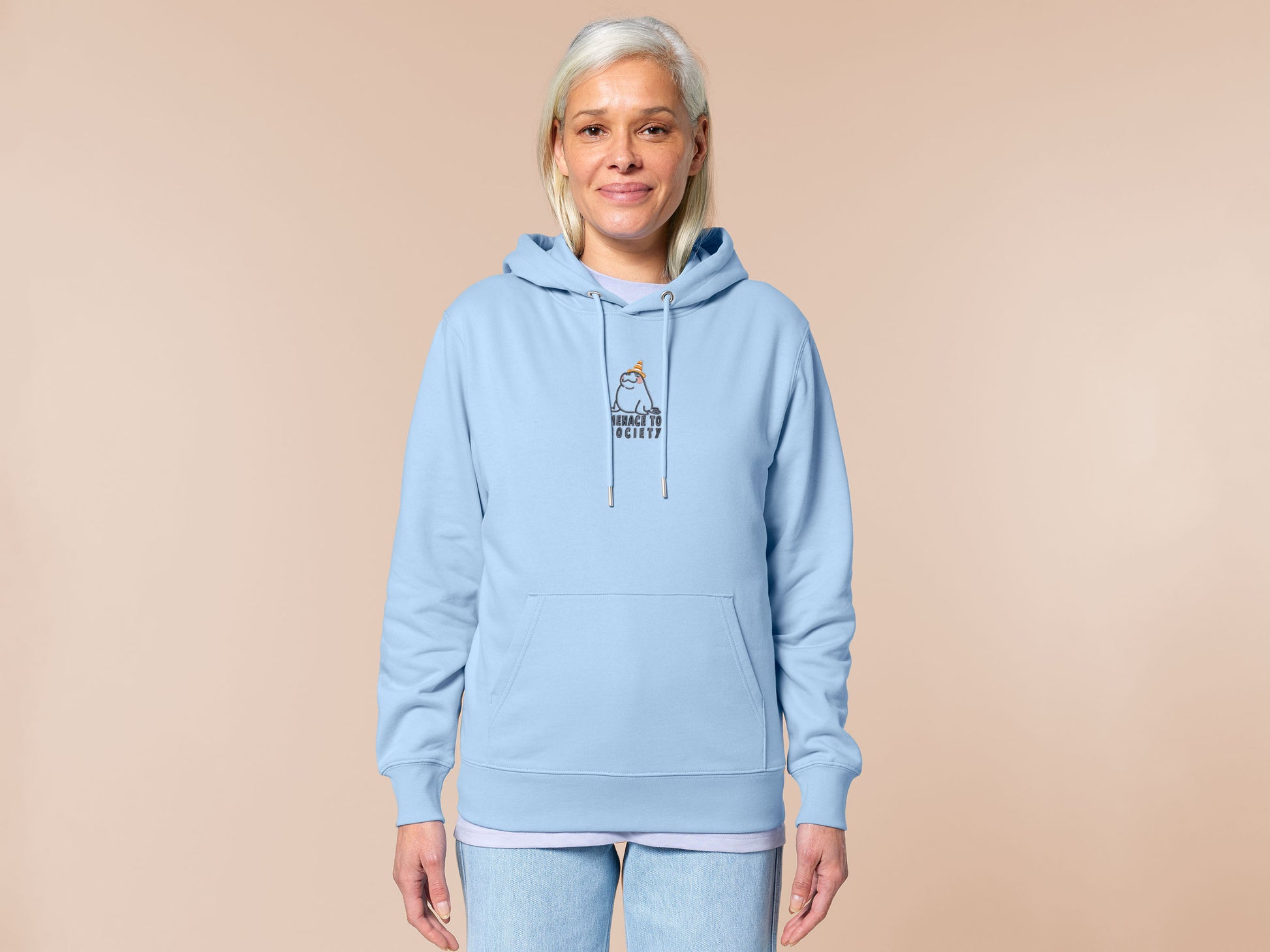 Hoodie with an embroidered blue design of a cute Neal the seal smuggly wearing an orange and white trafic cone with the quote meance to society