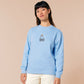 Sweater with an embroidered blue design of a cute Neal the seal smuggly wearing an orange and white trafic cone with the quote meance to society