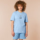 T-shirt with an embroidered blue design of a cute Neal the seal smuggly wearing an orange and white trafic cone with the quote meance to society