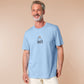 T-shirt with an embroidered blue design of a cute Neal the seal smuggly wearing an orange and white trafic cone with the quote meance to society
