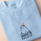 T-shirt with an embroidered blue design of a cute Neal the seal smuggly wearing an orange and white trafic cone with the quote meance to society